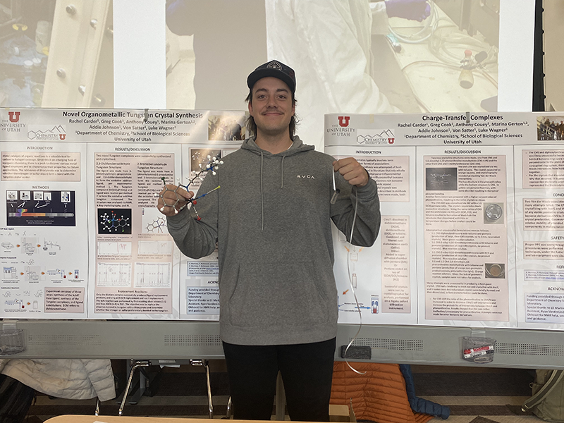 A student at the poster session displaying models