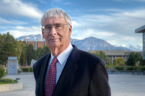 Peter Stang looks at the camera with mountains in the background